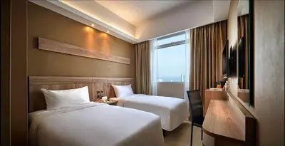 a hotel room with two beds and a window at Cititel Express Penang in George Town