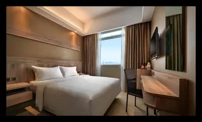 a hotel room with a bed and a window at Cititel Express Penang in George Town