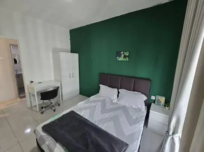 a bedroom with a green wall and a bed at Stay at Anderson Condo 161 Ipoh Town FREEWIFITVBOX in Ipoh