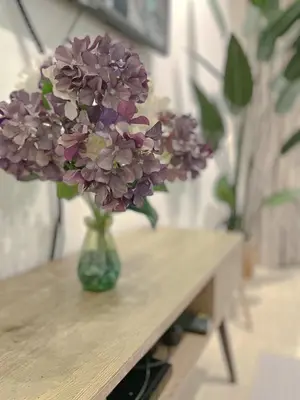 a vase of purple flowers sitting on a table at Zara Cozy Homestay in Seri Iskandar