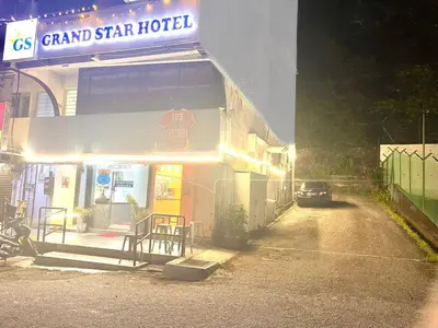 a car parked outside of a grand star hotel at night at Grand Star Hotel in Batu Ferringhi