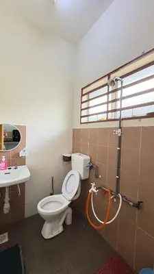 a bathroom with a toilet and a sink at Home-Away Homestay in Gerik