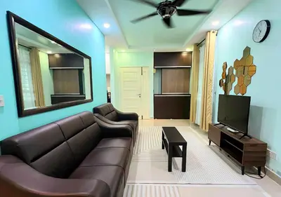 a living room with a couch and a flat screen tv at Homestay Pulau Pinang Urban Sky Guesthouse in Bayan Lepas