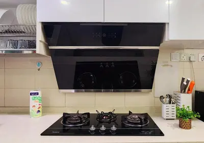 a black stove top in a kitchen with a microwave at Homestay Pulau Pinang Urban Sky Guesthouse in Bayan Lepas