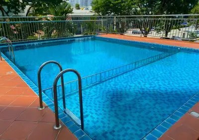a large blue swimming pool with two metal rails at Homestay Pulau Pinang Urban Sky Guesthouse in Bayan Lepas