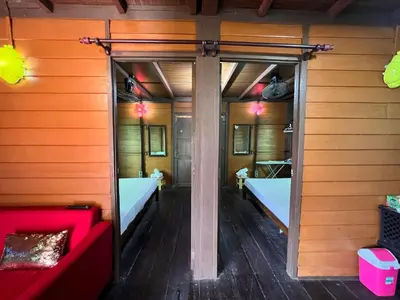 a room with two beds and a red couch at Homestay Jasmin in Taiping