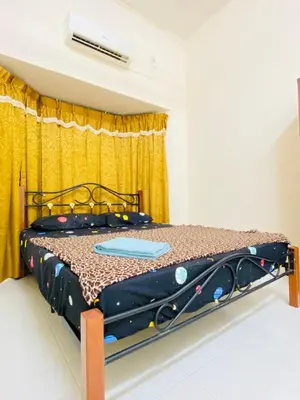 a bed in a room with a yellow curtain at No 115 Homestay Tasik Raban Lenggong in Kampong Kuala Chegar