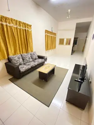 a living room with a couch and a coffee table at No 115 Homestay Tasik Raban Lenggong in Kampong Kuala Chegar