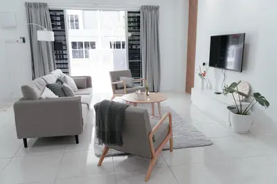 a living room with two chairs and a tv at Taiping Homestay 5R3B, 9mins - Zoo & Lake Garden Taiping in Taiping