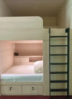 a bedroom with a bunk bed and a ladder at Milan Backpacker Hostel in George Town