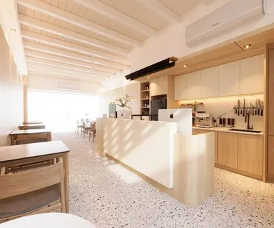 a large kitchen with white appliances and a counter at Milan Backpacker Hostel in George Town