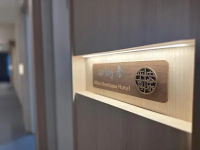 a wooden door with a sign on it at Milan Backpacker Hostel in George Town