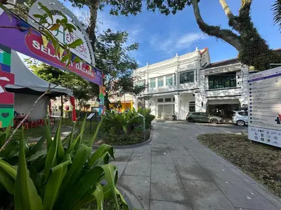 a street in front of a white building at Milan Backpacker Hostel in George Town