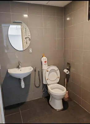 a bathroom with a toilet and a sink at Seri Sayang 2 Bedrooms Seaview Resort in Batu Ferringhi