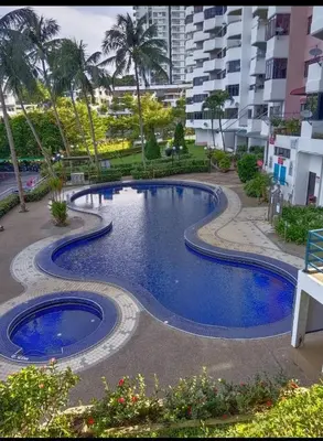 a swimming pool in the middle of a resort at Seri Sayang 2 Bedrooms Seaview Resort in Batu Ferringhi