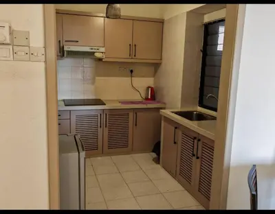 a small kitchen with a sink and a refrigerator at Seri Sayang 2 Bedrooms Seaview Resort in Batu Ferringhi