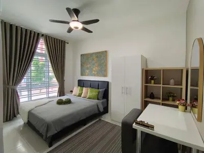a bedroom with a bed and a ceiling fan at Suri Homestay Anderson Ipoh in Ipoh