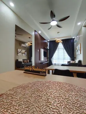 a bedroom with a large bed with a ceiling fan at Suri Homestay Anderson Ipoh in Ipoh
