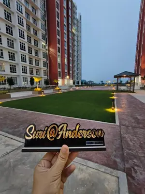 a hand holding a sign in front of a park at Suri Homestay Anderson Ipoh in Ipoh