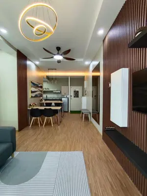 a living room with a table and a ceiling fan at Suri Homestay Anderson Ipoh in Ipoh