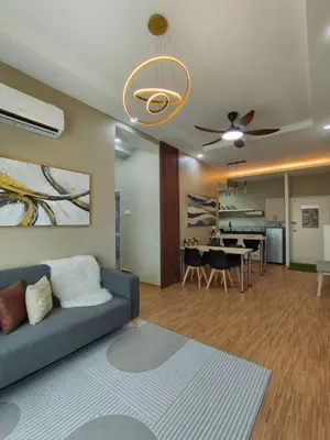 a living room with a couch and a dining room at Suri Homestay Anderson Ipoh in Ipoh