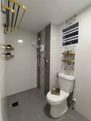 a bathroom with a white toilet and a shower at Suri Homestay Anderson Ipoh in Ipoh