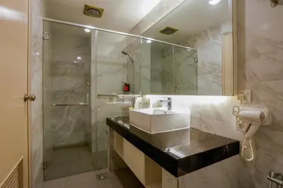 a bathroom with a sink and a shower at The Host Hotel in Ipoh