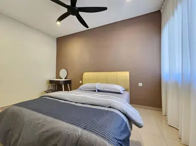 a bedroom with a bed with a ceiling fan at Sunway Homestay 8pax 2Bath in Perai