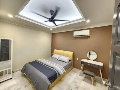 a bedroom with a bed with a ceiling fan at Sunway Homestay 8pax 2Bath in Perai