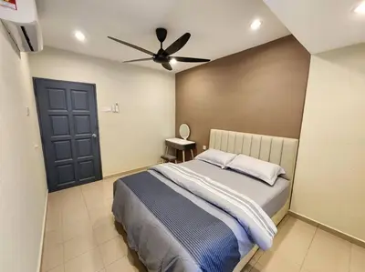 a bedroom with a bed and a ceiling fan at Sunway Homestay 8pax 2Bath in Perai