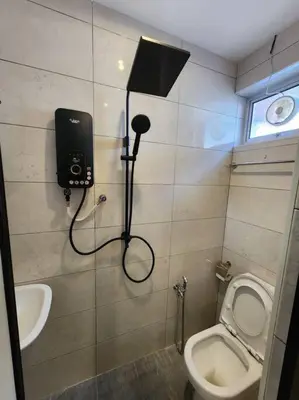 a bathroom with a toilet and a camera on the wall at Sunway Homestay 8pax 2Bath in Perai