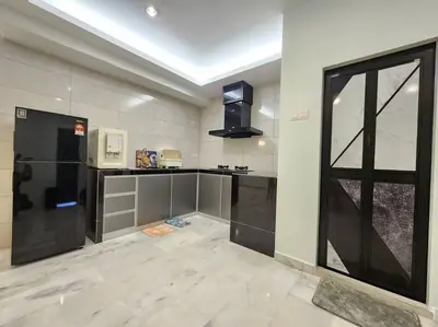 a kitchen with a black refrigerator and a window at Sunway Homestay 8pax 2Bath in Perai