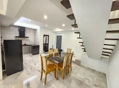 a kitchen and dining room with a table and chairs at Sunway Homestay 8pax 2Bath in Perai