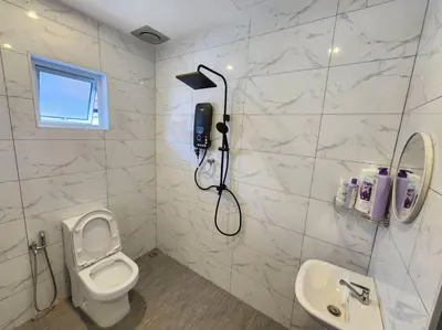 a bathroom with a shower and a toilet and a phone at Sunway Homestay 8pax 2Bath in Perai