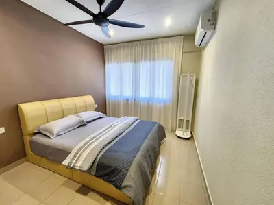 a bedroom with a bed with a ceiling fan at Sunway Homestay 8pax 2Bath in Perai