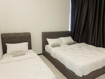 two beds sitting next to each other in a bedroom at relax familystay -Urban suites-3BR-10pax in Jelutong