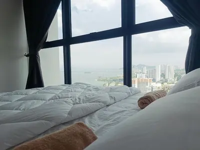 a large window with a large bed in a bedroom at relax familystay -Urban suites-3BR-10pax in Jelutong