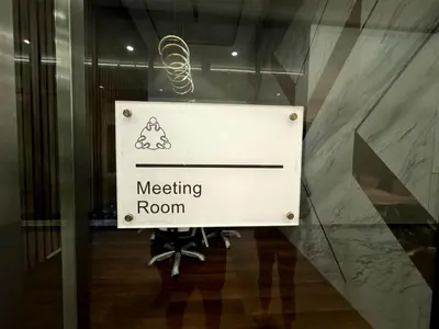 a sign in a glass door of a meeting room at relax familystay -Urban suites-3BR-10pax in Jelutong