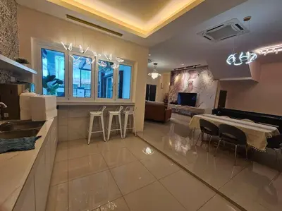 a large kitchen with a table and chairs in a room at jia Residence 21 pax Karaoke & Snooker in Ipoh