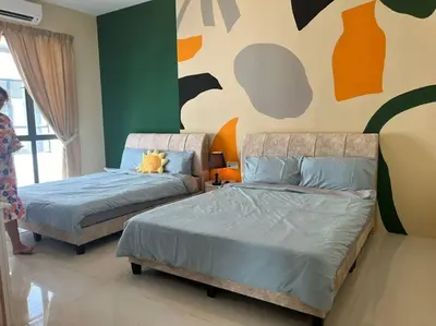 a bedroom with two beds and a painting on the wall at Happiness Stay 20pax Karaoke & Snooker in Ipoh