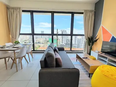 a living room with a couch and a large window at Sunlit Minimalist Suite, 7 Pax at Urban Suites Georgetown by SuperStay in Jelutong