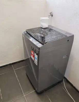 a machine with a cup on top of it at Sunlit Minimalist Suite, 7 Pax at Urban Suites Georgetown by SuperStay in Jelutong