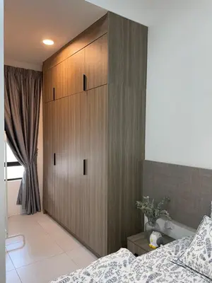 a bedroom with a large wooden cabinet next to a bed at The Imans Place in Kepala Batas