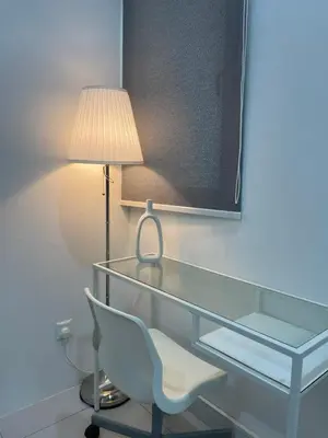 a glass desk with a chair and a lamp at The Imans Place in Kepala Batas