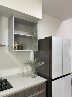 a kitchen with a black and white refrigerator at The Imans Place in Kepala Batas