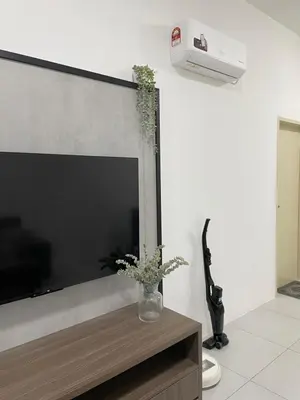 a living room with a large flat screen tv on a wall at The Imans Place in Kepala Batas
