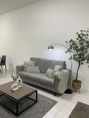 a living room with a couch and a table at The Imans Place in Kepala Batas