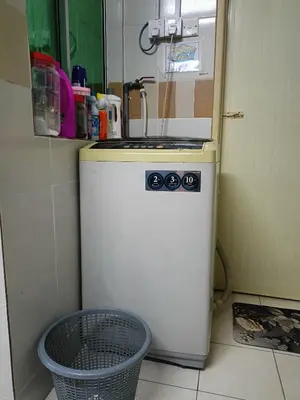 a small refrigerator in a kitchen with a sink at Seri Raban Homestay in Kampong Kuala Chegar