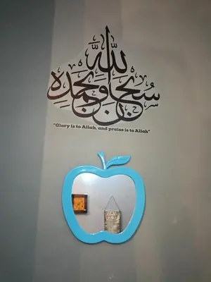 a sign with an apple and a picture of a building at Seri Raban Homestay in Kampong Kuala Chegar