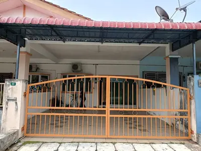 an orange gate in front of a house at Seri Raban Homestay in Kampong Kuala Chegar